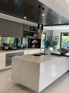 a large kitchen with an island in the middle and lots of counter space around it