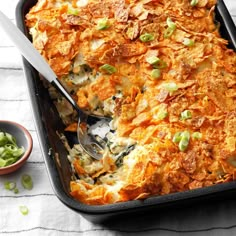 a casserole dish is shown with a spoon in it