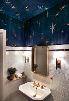 a bathroom with stars painted on the ceiling and white tile walls, along with a gold framed mirror