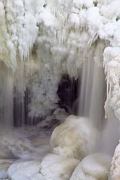 the water is running down the ice covered waterfall