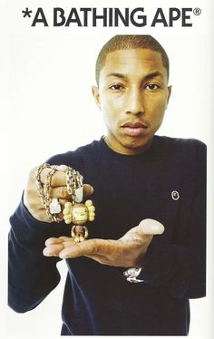 a young man is holding several bracelets in his hands while wearing a black shirt