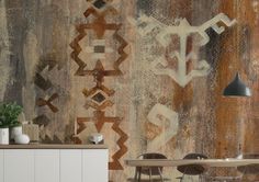 an artistic wallpaper with abstract designs on the walls and chairs in front of it