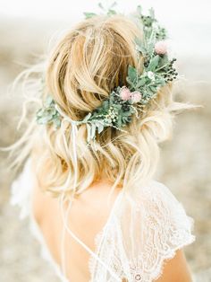 a woman with blonde hair wearing a flower crown