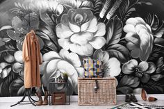 a black and white floral wall mural in an entryway with wicker baskets on the floor