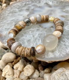 Beautiful light colored beads mixed with wood creates this summery piece ☀️ Bracelet also includes 2 small flower beads. 1 yellow - 1 white  Can be worn alone or stacked  Handcrafted with Love 🐚  Please note: Contains small parts, not recommended for children 0-3. Children over this age should be supervised if wearing. Bohemian Wooden Beads Stretch Bracelet For Meditation, Spiritual Wooden Beads Bracelets For Beach, Brown Beaded Bracelets With Natural Stones For Beach, Brown Natural Stones Beaded Bracelets For Beach, Brown Natural Stone Beaded Bracelets For Beach, Bohemian Wooden Beads Stretch Bracelet For Beach, Handmade Adjustable Beaded Bracelets In Natural Wood, Bohemian Bracelets For Festival, Handmade Adjustable Natural Wood Beaded Bracelets