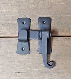 a close up of a metal latch on a wooden door