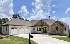 a large house with two garages in the front yard