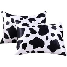 two black and white cow print pillows