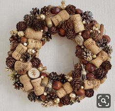 a wreath made out of wine corks and pine cones