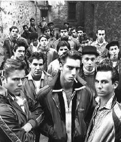 black and white photograph of men standing in an alleyway