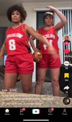 two women in red basketball uniforms standing next to each other with their hands on their hips