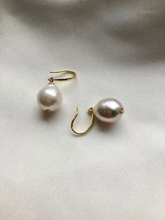 Our best selling classy and timeless Baroque pearl earrings.  The pearls are in the perfect size not too large or small, around 12-13mm in height, in rounded teardrop shape, dangling on a pair of 18k gold plated solid silver ear hoops. These beautiful earrings are timeless classic and easy to go with any outfits. Gold vermeil earring hooks version also available, select style at basket.  Due to the nature of natural pearls, every baroque pearl has little defects and marks on surface and is sligh Classic Round Pearl Earrings With French Hook, Classic Pearl Earrings With French Hook, Classic Teardrop Earrings With Pearl Pendant, Classic Pearl Earrings With French Hook As Gift, Classic Pearl Pendant Teardrop Earrings, Classic Teardrop Pearl Pendant Earrings, Formal Pearl Charm Earrings, Elegant Baroque Pearl Drop Earrings, Formal Pear-shaped Pearl Charm Earrings