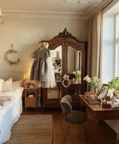 a bedroom with a bed, dresser and mirror in it's centerpieces