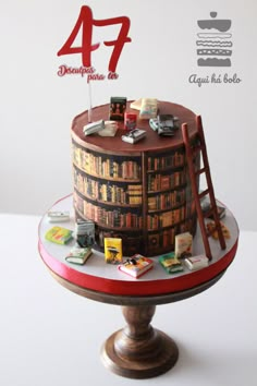 the cake is decorated with books and ladders