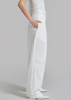 Color: White Lightweight cotton blend fabric Wide leg High rise Pleat front detail Pressed crease Side seam pockets Single illusion welt back pocket Belt loops Hook and bar closure Zip fly Unlined 97% Cotton 3% Polyurethane Dry Clean By The Frankie Shop. Imported *Style runs large; refer to measurements