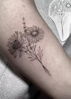 a black and white photo of flowers on the arm