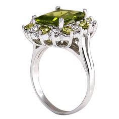 Stamped: 14K White GoldTotal Ring Weight: 6.5 GramsRing Length: N/ARing Width: N/AGemstone Weight: Total Natural Peridot Weight is 4.27 Carat (Measures: 11.06x8.87mm)Color: GreenDiamond Weight: Total Natural Diamond Weight is 0.70 CaratColor: F-G, Clarity: VS2-SI1Face Measures: 18.42x16.83 mmSku: [702688W] 14k White Gold Diamond Ring, White Gold Diamond Rings, Gold Diamond Ring, Green Diamond, Green Peridot, Birthstone Ring, White Gold Diamonds, Precious Metals, Gold Diamond