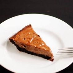 a piece of chocolate pie on a white plate with a fork