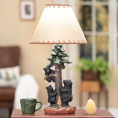 a lamp that is sitting on top of a table next to a bear figurine