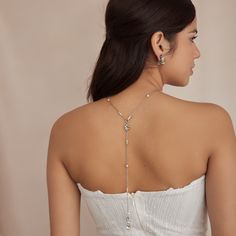 Dive into elegance with our Evangeline necklace, a delicate silver-tone metal chain necklace with dainty Czech glass pearls. This versatile necklace also creates the perfect drop design in back, accentuating your gown from all sides. All Ben-Amun jewelry is handcrafted and made to order in New York City, so please allow 7-14 business days for production before the ship date. Measurements: 26" L Silver Backdrop Necklace With Adjustable Chain For Party, Elegant Pearl Backdrop Necklace With Delicate Chain, Silver Drop Necklace With Pearl Chain For Party, Silver Pearl Chain Drop Necklace For Party, Dainty Silver Clavicle Body Chain, Silver Delicate Chain Backdrop Necklace For Party, Delicate Adjustable Body Chain For Wedding, Delicate Adjustable Wedding Body Chain, Elegant Lariat Necklace For Wedding With Clavicle Chain