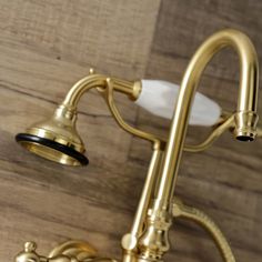 the brass faucet is attached to the wooden wall