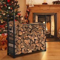 a pile of logs sitting next to a christmas tree in front of a fire place