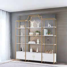 a white and gold bookcase in a living room with grey walls, rugs and curtains