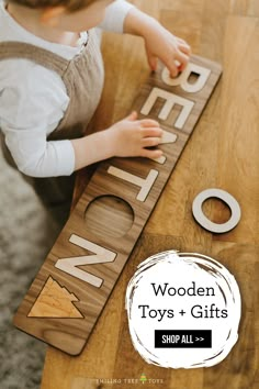 a young boy playing with wooden toys and gifts