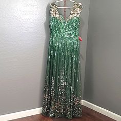 New With Tags Mac Duggal Sequin Floral Embellished Evening Gown Dress Sage Green Size 16 Floor-Length Evening Gown Cascading Sequin Stripes, Exquisite 3d Floral Embellishments At The Shoulders And Bottom Hem, And A Sweeping A-Line Hem. Mac Duggal Sequin Fabric (100% Polyester) Fully Lined V-Neck Cap Sleeve 3d Floral Embellishments Concealed Back Zipper Approx. 62.5" From Top Of Shoulder To Bottom Hem Style #5223 Embellished Floor-length Maxi Dress For Evening, Floor-length Embellished Mother Of The Bride Dress, Festive Floor-length Evening Dress, Festive Green Evening Dress For Prom, Festive V-neck Embellished Maxi Dress, Glamorous Embellished Green Maxi Dress, Festive Green Sequined Dress, Festive Green Evening Gown, Sleeveless Embellished Maxi Dress For Festive Occasions