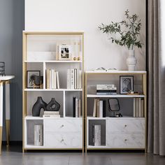 a living room with white and gold bookshelves