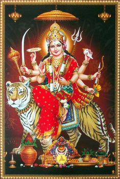 the hindu goddess sitting on top of a tiger