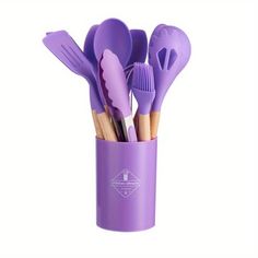 a purple cup filled with lots of different types of utensils