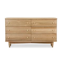 the chest of drawers is made from wood and has brass knobs on each drawer