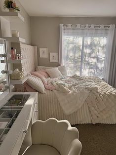 a bedroom with a bed, dresser and chair next to a window in the room