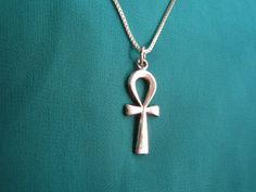 "Beautiful Egyptian Sterling Silver Ankh necklace. The ankh is an ancient Egyptian hieroglyphic symbol that was most commonly used in writing and in art to represent the word for \"life\" and, by extension, as a symbol of life itself. The sign has a cross shape but with an oval loop in place of an upper bar. It signified wisdom and insight on the highest level and it was also a fertility symbol. The ankh was widely used as an amulet in Ancient Egypt. Also commonly known as the \"cross of life\" Cheap Ankh Shaped Metal Jewelry, Cheap Ankh Shaped Spiritual Jewelry, Cheap Metal Ankh Jewelry, Cheap Silver Ankh Necklace, Spiritual Ankh Necklace Nickel Free, Spiritual Nickel-free Ankh Necklace, Sterling Silver Ankh Necklace, Ankh Egyptian, Egyptian Hieroglyphics Symbols