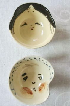 two small bowls with faces painted on them