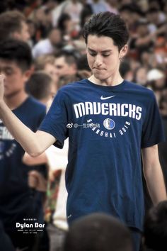 a young man standing in front of a crowd