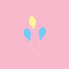 two balloons floating in the air on a pink background