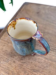 a coffee cup sitting on top of a wooden table