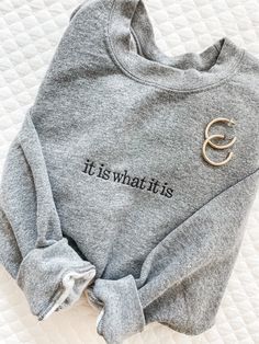 "Our IT IS WHAT IT IS Sweatshirt is going to be your new closet favorite. With so many colors to choose from and at such a great price, you can buy one for your BFF as well!! These are unisex sizing. Sample shown in Graphite Heather and Black thread. 8-ounce, 50/50 cotton/poly Double-needle stitching at waistband and cuffs 1x1 rib knit collar, cuffs and waistband with spandex **NOT PROVIDING ALL OF THE REQUIRED INFORMATION FOR PERSONALIZATION WILL DELAY YOUR ORDER.** When checking out, put this New Closet, Bachelorette Gifts, Black Thread, Embroidered Sweatshirt, Loungewear Sets, Fall Shopping, Embroidered Sweatshirts, Embroidery Ideas, Health Awareness