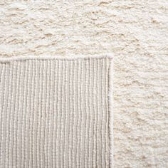 a close up view of a white rug