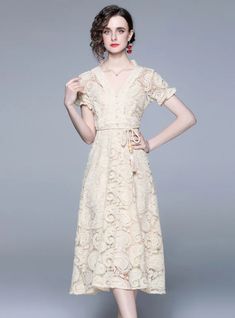 Ornamented with intricate lace detailing, this knee-length dress combines classical charm with modern elegance. The neutral champagne hue enhances the delicate patterns woven into the fabric, creating a subtle yet sophisticated visual appeal. Designed with short flutter sleeves and a V-neckline, this dress flatters with a gentle, feminine silhouette that cinches at the waist before flowing down gracefully. The inclusion of a slim, rope-like belt with tassel ends allows for a customizable fit, ac Short Skater Dress, Sleeve Long Dress, Flowy Romper, Black Dress With Sleeves, Lace Short, Lantern Sleeve, Short Sleeve Dress, Lantern Sleeves, Contemporary Fashion