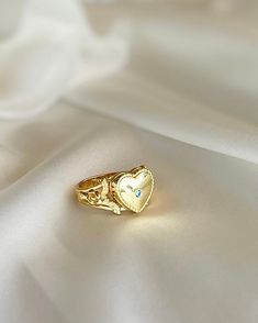 This Heart Locket Ring is crafted from gold plated silver for a luxurious feel and timeless look. Its elegant design is perfect for the special occasions that call for you to make a powerful, romantic statement. Wear it to express love, adoration, or devotion. Elegant Gold-plated Flower Ring, Elegant Wedding Crystal Ring Tarnish Resistant, Silver Crystal Ring, Gold Plated For Anniversary, Silver Crystal Ring For Wedding, Tarnish Resistant, Gold Plated Tarnish Resistant Crystal Ring As Gift, Elegant Gold Flower Metal Ring, Silver Tarnish-resistant Crystal Wedding Ring, Gold Crystal Promise Ring For Valentine's Day, Gold Heart Ring Suitable For Wedding