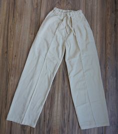 Look fashionable and feel comfortable in these XL beige woven Boho pants. A perfect blend of style and comfort, these pants feature tribal patterns with an adjustable leg and waist to ensure the perfect fit. These hippie pants are lightweight and breathable, making them ideal for summer days. It has 2 pockets in the front and 1 pocket in the back.Materials:100% Cotton Measurements:Waist circumference: 28" stretches up to 38"Hip circumference: 48"Rise: 13"Inseam: 30"Total Length: 44"Thigh: 12"Leg Casual Cream Wide Leg Pants With Elastic Waistband, Casual Beige Wide Leg Pants, Loosely Fitted Hips, Casual Beige Harem Pants For Vacation, Beige Linen Casual Harem Pants, Beige Bohemian Pants With Pockets, Beige Pants With Elastic Waistband And Loosely Fitted Hips, Casual Beige Linen Harem Pants, Loosely Fitted Beige Pants With Elastic Waistband, Beige Straight Leg Harem Pants For Summer