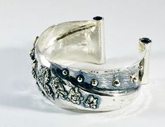 Large Modernist silver bracelet designed by Reijo Raitila, for Raitila & Kni Ky, Tampere Finland 1965. The bracelet has an very interesting structure and a weight of 51 grams! The inner diameter of the bracelet is 69mm x 55mm and the bracelet is 30mm wide. It is a open version , therefore a little bit adjustable in the size. Hallmarks: Manufacturer Mark for Raitila & Kni Ky Crown in Heart / Finnish National Mark 916H / Silver purity mark Tampere City Mark M7 / Finland Year Mark 1965 Plea Handcrafted Silver Bangle, Artistic Silver Bangle Bracelets, Artistic Silver Bangle Bracelet, Artistic Silver Bangle Jewelry, Artistic Silver Bangle, Artistic Silver Bracelets For Formal Occasions, Silver Artistic Bracelets For Formal Occasions, Unique Silver Bracelets For Anniversary, Unique Polished Bracelets For Wedding