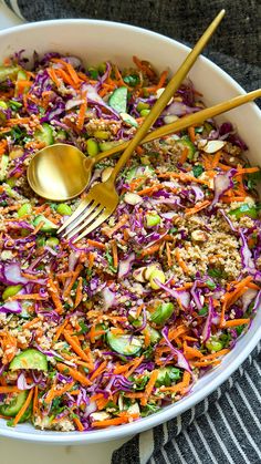 a bowl filled with coleslaw, carrots, and cucumber salad