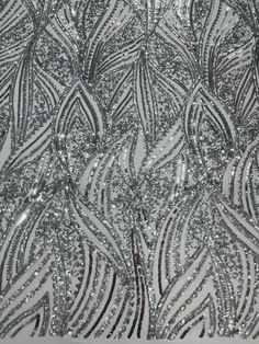 silver sequins on white fabric with wavy lines