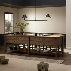 a large wooden table sitting inside of a living room