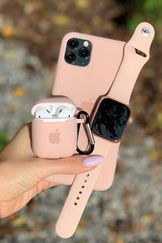 a person holding an apple watch and airpods in their hand