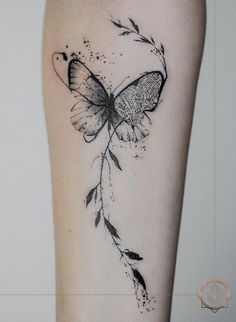 a black and white butterfly tattoo on the leg